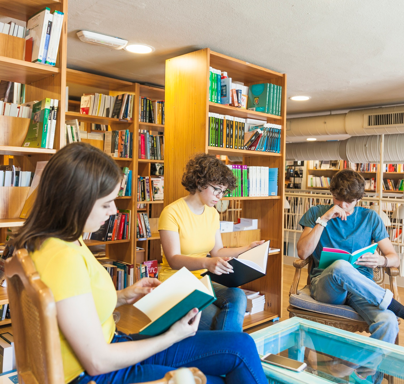 People grabbing book in shelf